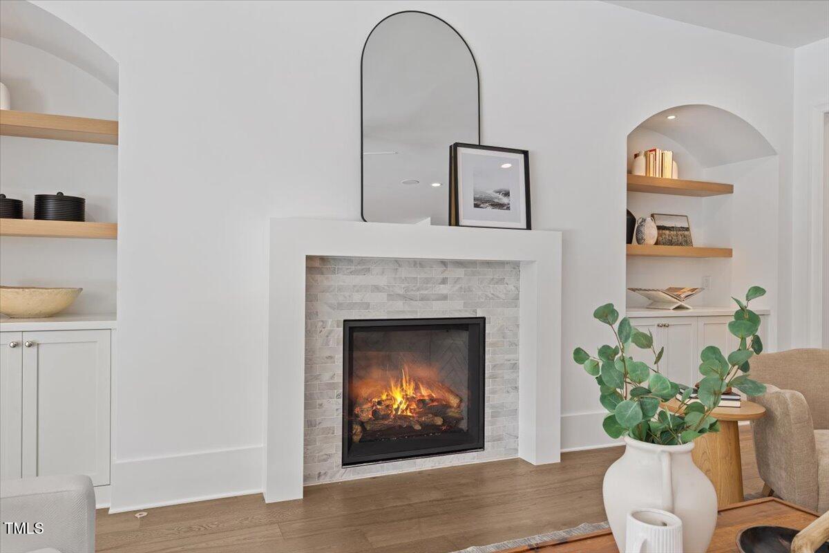 6844 Greystone Drive Raleigh, NC 27615 - Photo 20 of 83 a living room with a fireplace and a potted plant