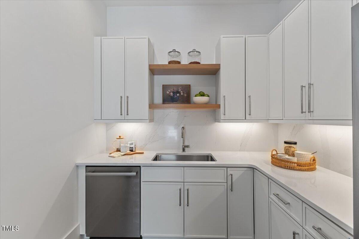 6844 Greystone Drive Raleigh, NC 27615 - Photo 24 of 83 a kitchen with stainless steel appliances granite countertop a sink a stove and cabinets