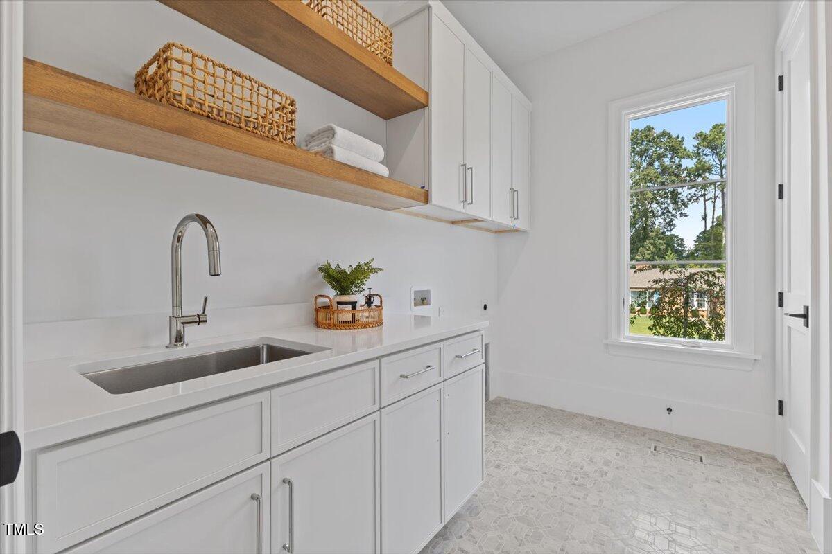 6844 Greystone Drive Raleigh, NC 27615 - Photo 29 of 83 a kitchen with a sink and cabinets