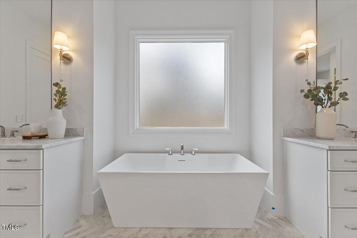 6844 Greystone Drive Raleigh, NC 27615 - Photo 36 of 83 a white bath tub sitting next to a bathroom sink