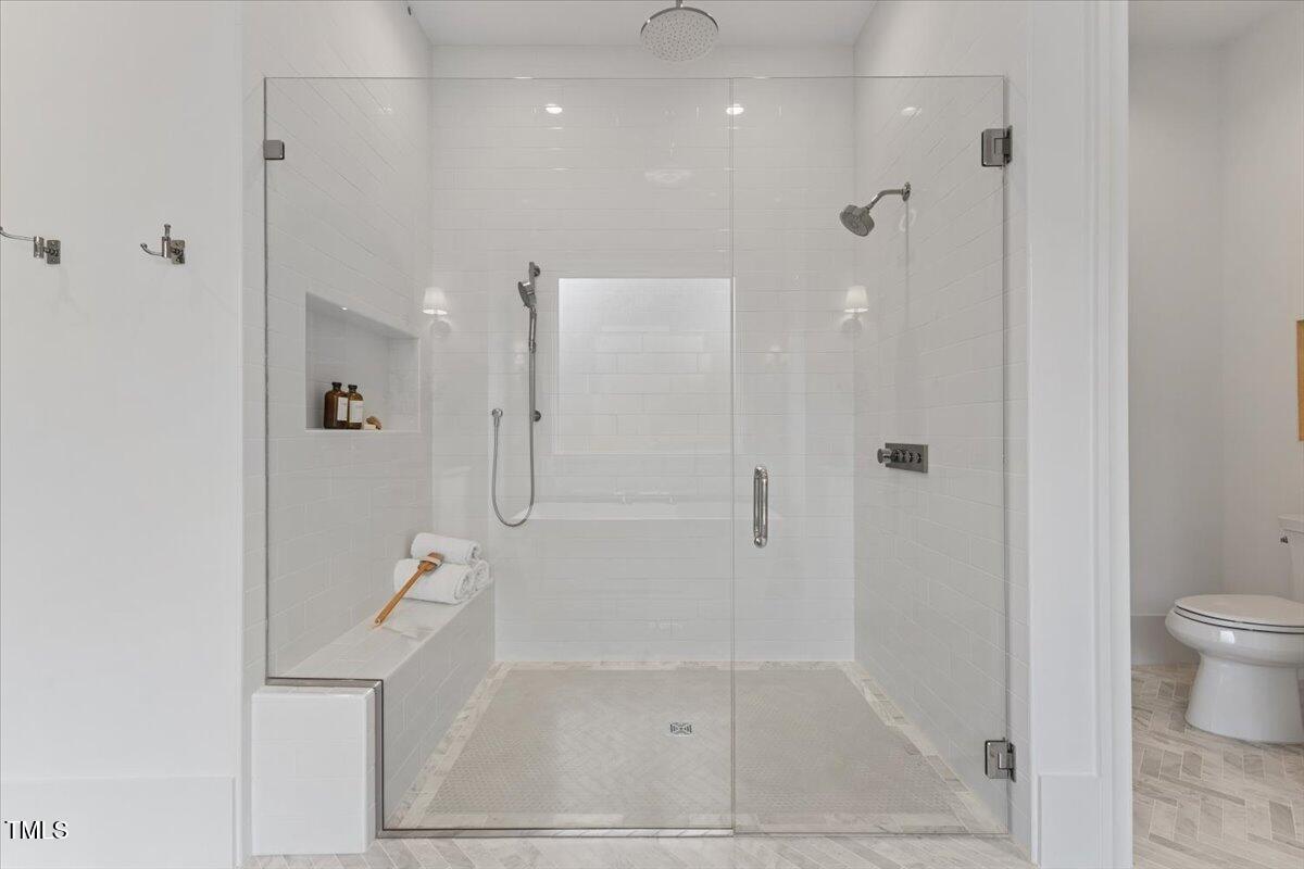 6844 Greystone Drive Raleigh, NC 27615 - Photo 37 of 83 a bathroom with a shower and toilet