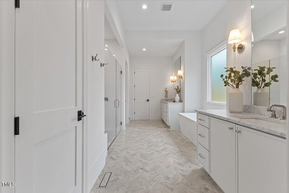 6844 Greystone Drive Raleigh, NC 27615 - Photo 41 of 83 a bathroom with a double vanity sink mirror and shower