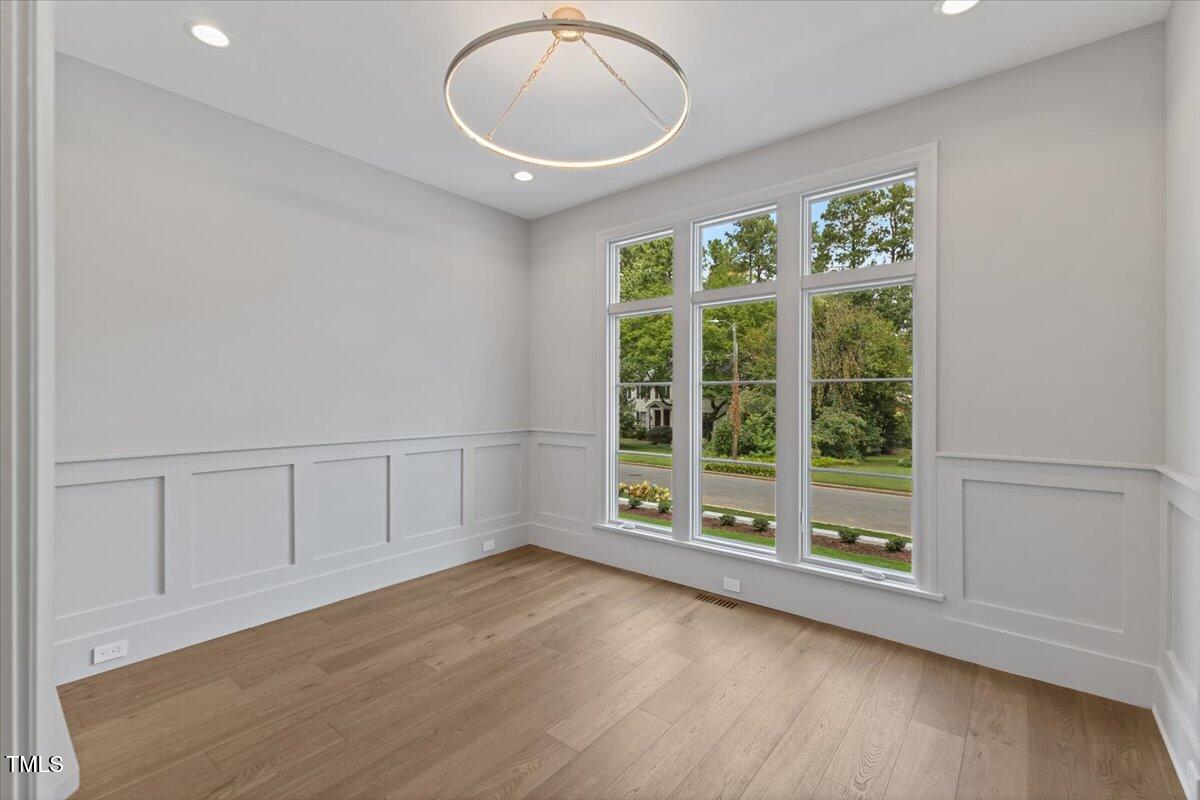 6844 Greystone Drive Raleigh, NC 27615 - Photo 42 of 83 a view of an empty room with wooden floor and a window