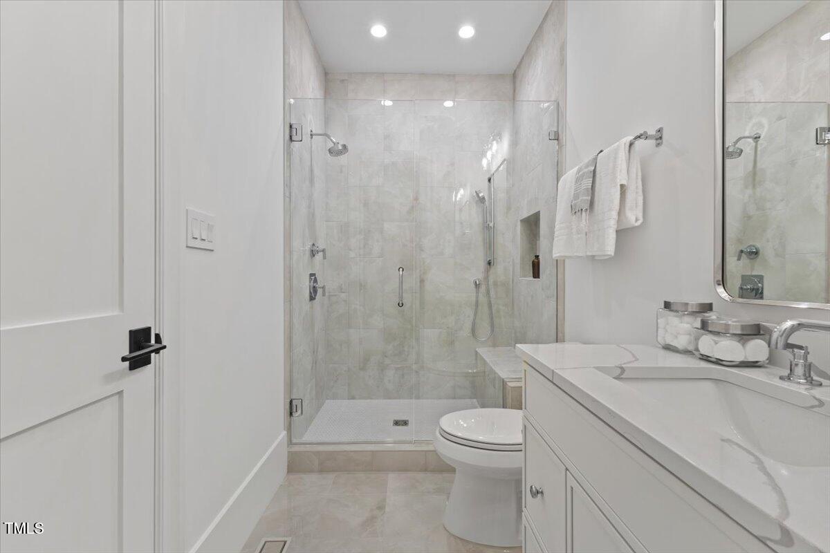 6844 Greystone Drive Raleigh, NC 27615 - Photo 45 of 83 a bathroom with a sink a toilet and shower