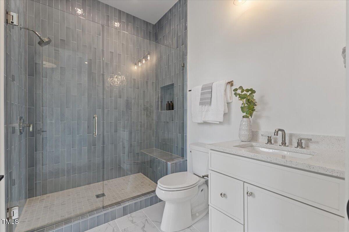 6844 Greystone Drive Raleigh, NC 27615 - Photo 50 of 83 a bathroom with a shower a toilet and a sink