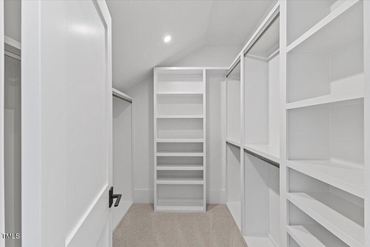 6844 Greystone Drive Raleigh, NC 27615 - Photo 61 of 83 a view of walk in closet with empty racks