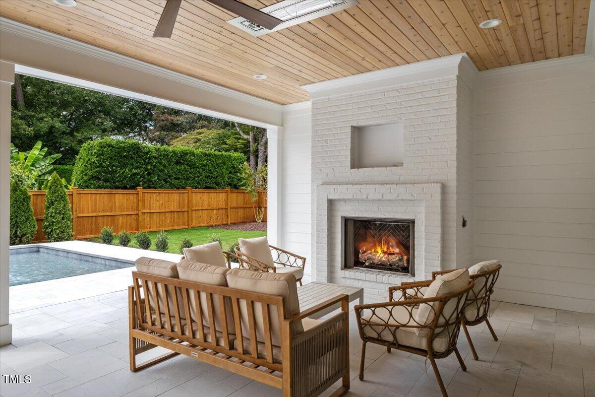 6844 Greystone Drive Raleigh, NC 27615 - Photo 75 of 83 a view of a patio with table and chairs with wooden floor and fence