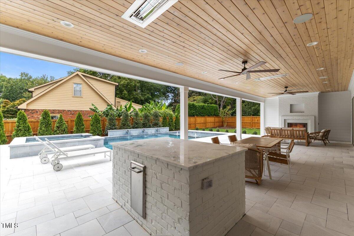 6844 Greystone Drive Raleigh, NC 27615 - Photo 77 of 83 a view of a patio with a table and chairs and a barbeque