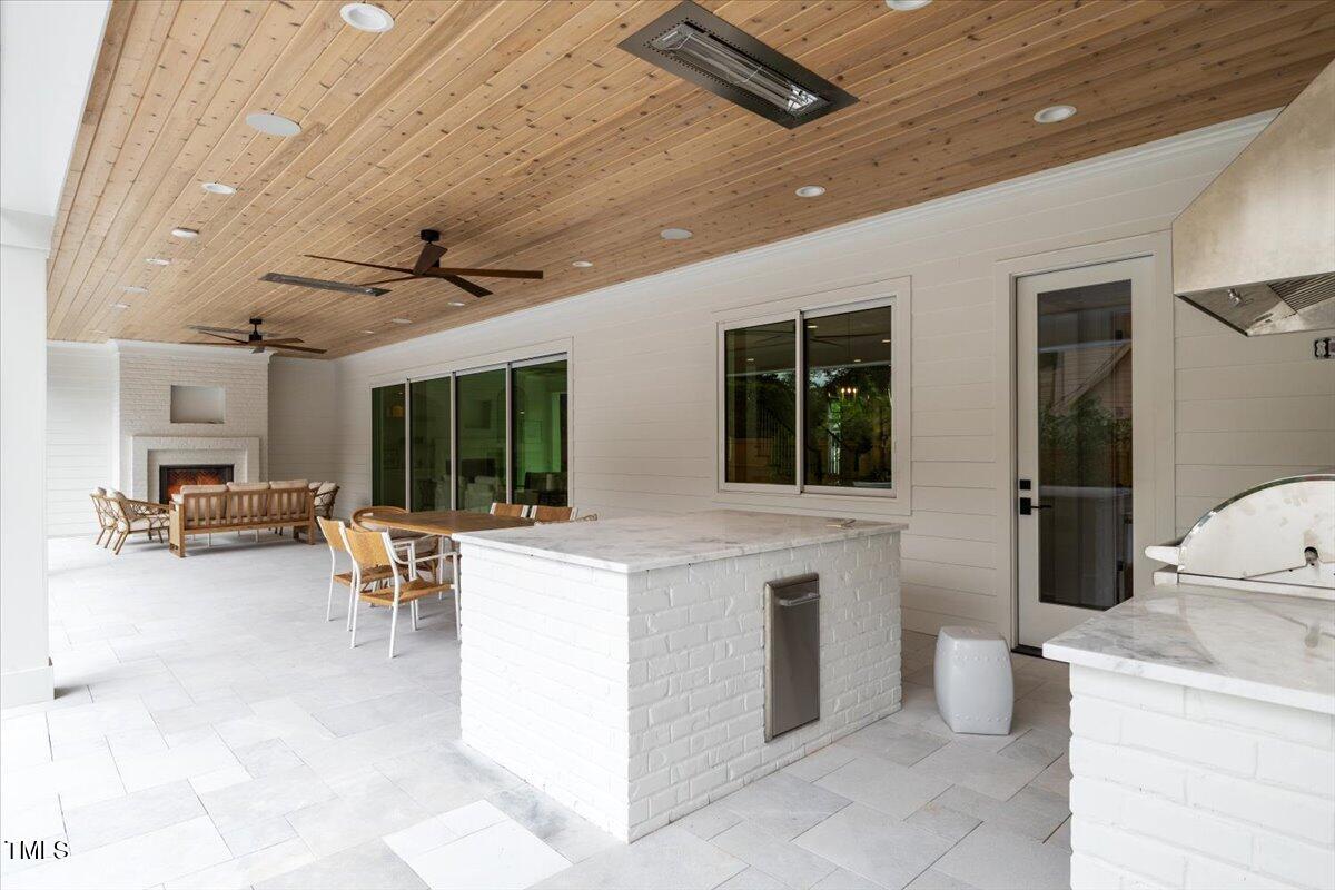 6844 Greystone Drive Raleigh, NC 27615 - Photo 78 of 83 a living room with furniture a fireplace and a table