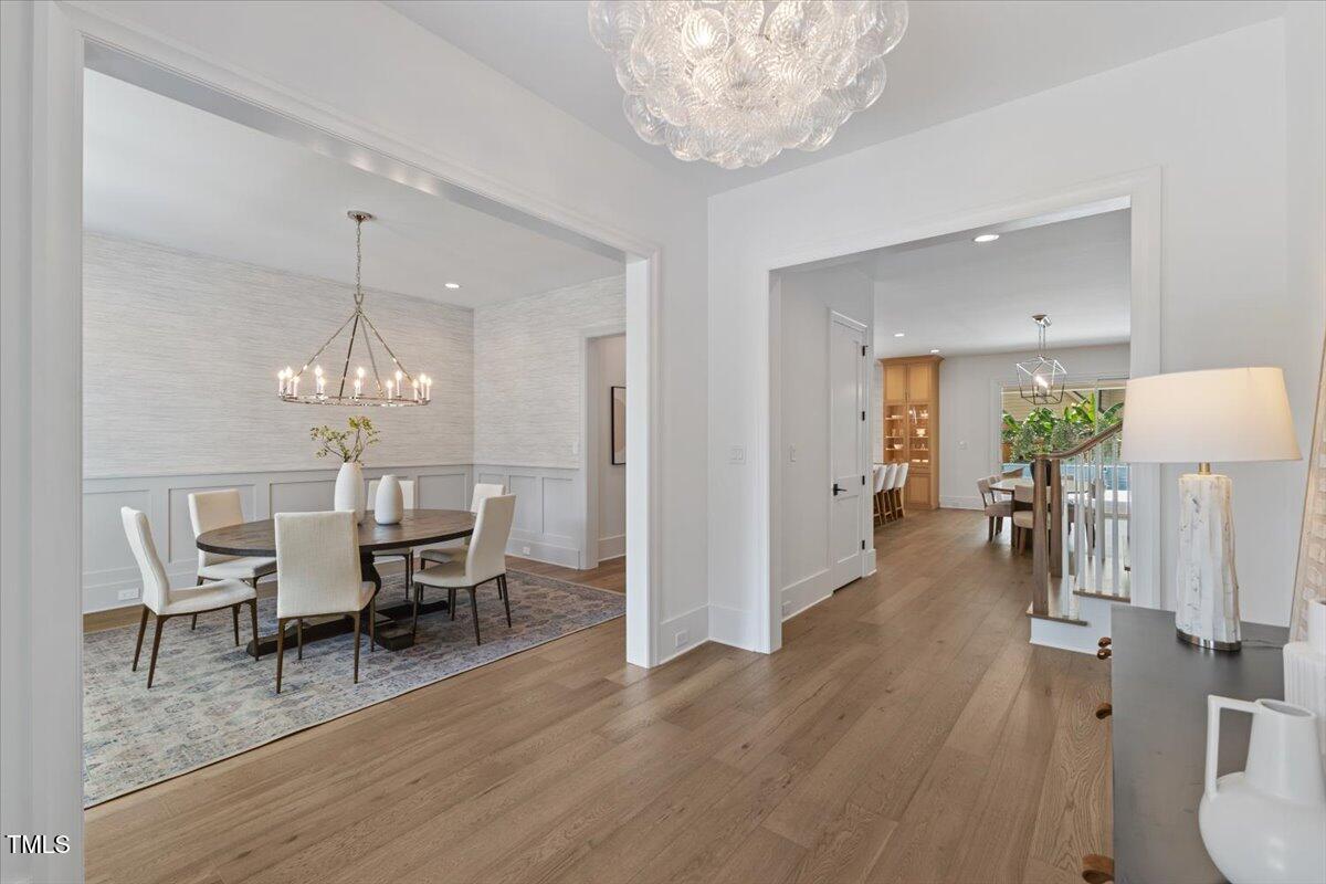 6844 Greystone Drive Raleigh, NC 27615 - Photo 9 of 83 a view of a dining room with furniture and wooden floor