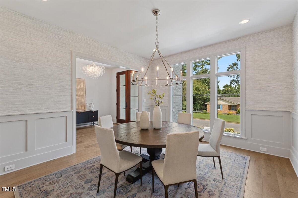 6844 Greystone Drive Raleigh, NC 27615 - Photo 10 of 83 a view of a dining room with furniture window and wooden floor