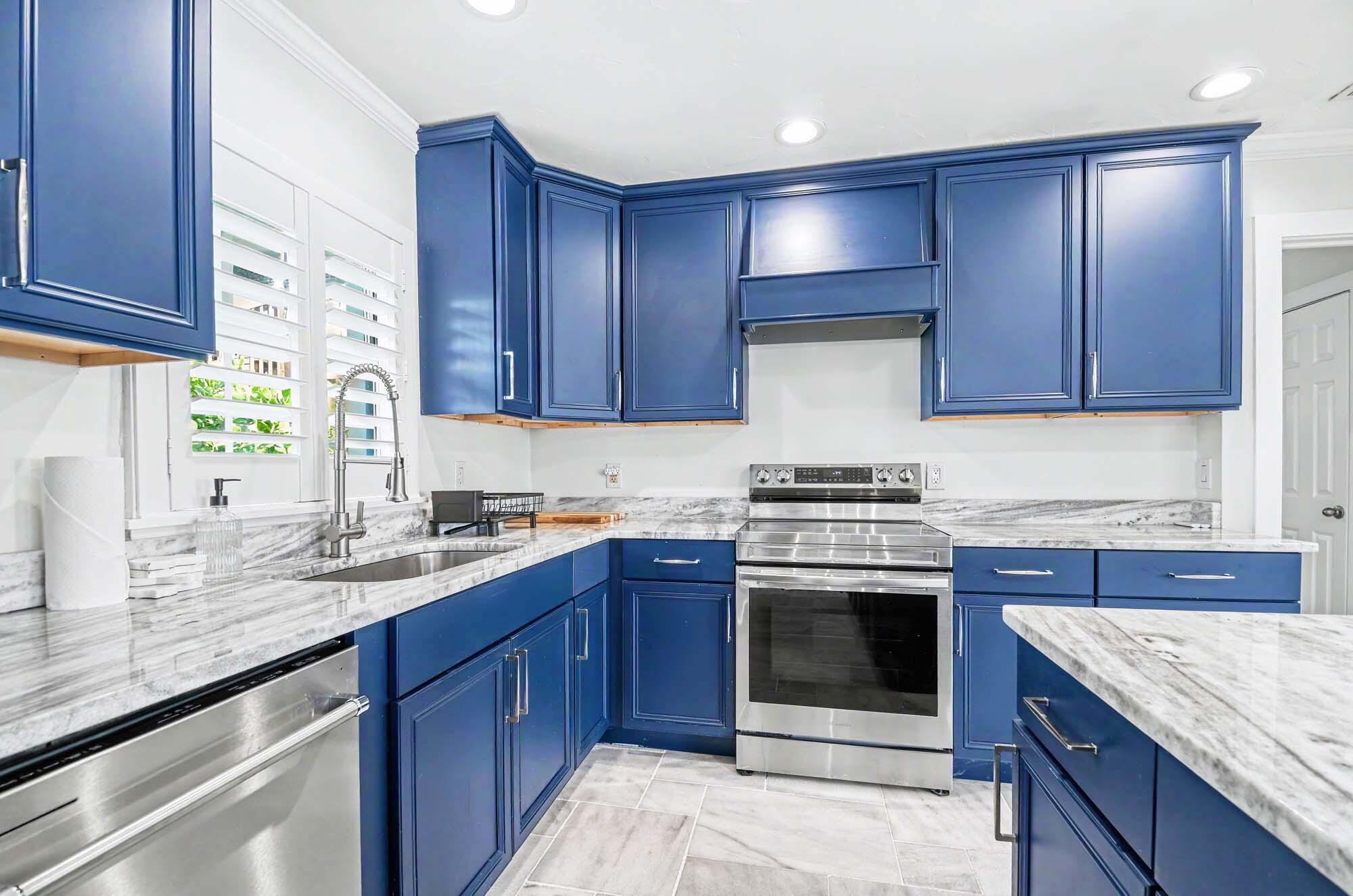 112 Capri Boulevard Naples, FL 34113 - Photo 10 of 29 a kitchen with stainless steel appliances granite countertop wooden cabinets stove top oven and sink
