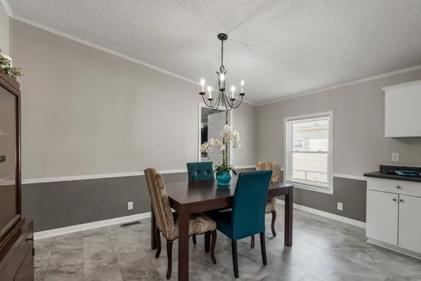 a view of a dining room with furniture and window