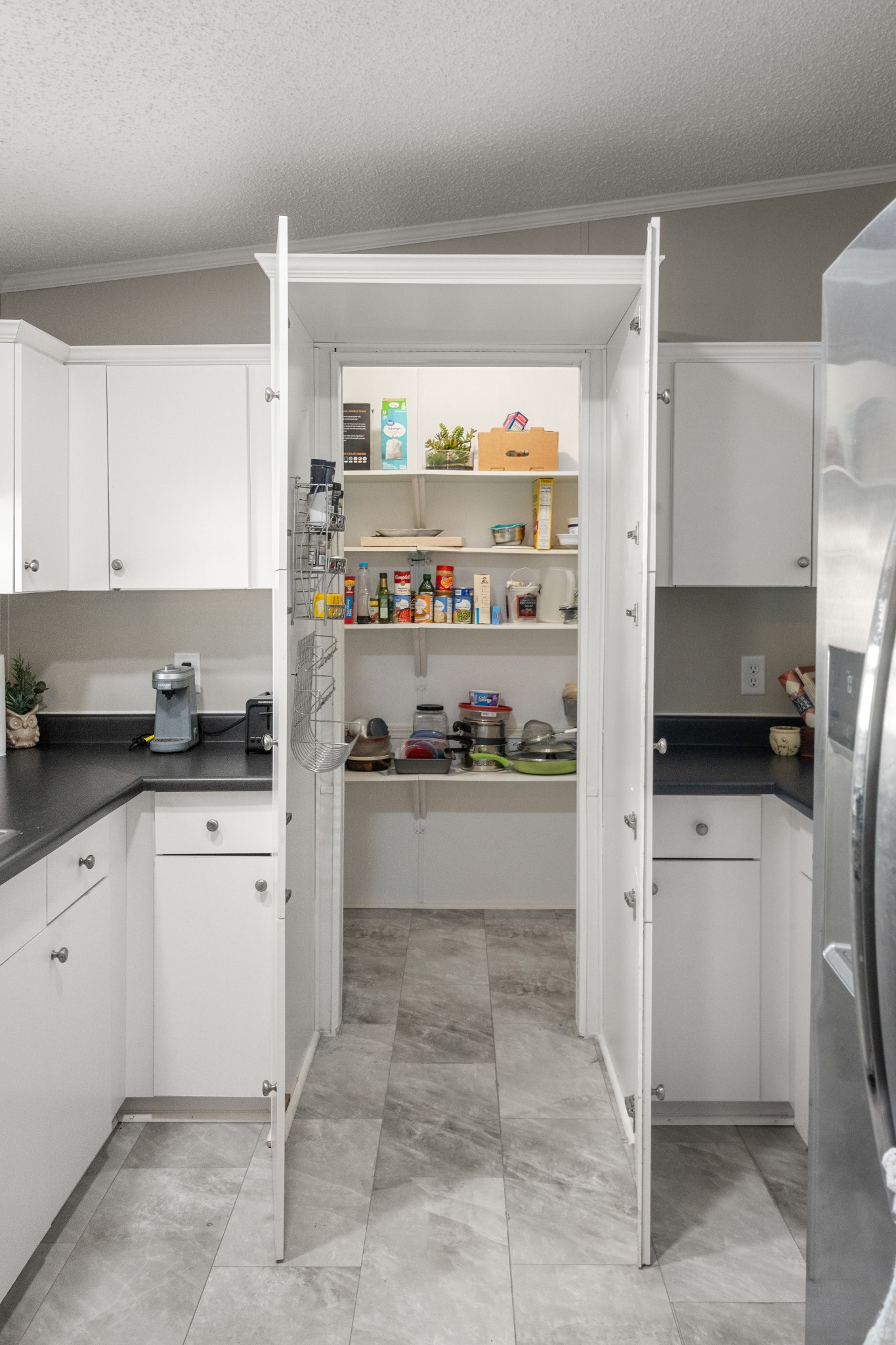 129 Broken Arrow Paris, TN 38242 - Photo 17 of 49 a kitchen with stainless steel appliances a refrigerator sink and cabinets