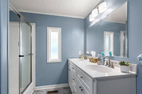 a bathroom with a sink double vanity and a mirror