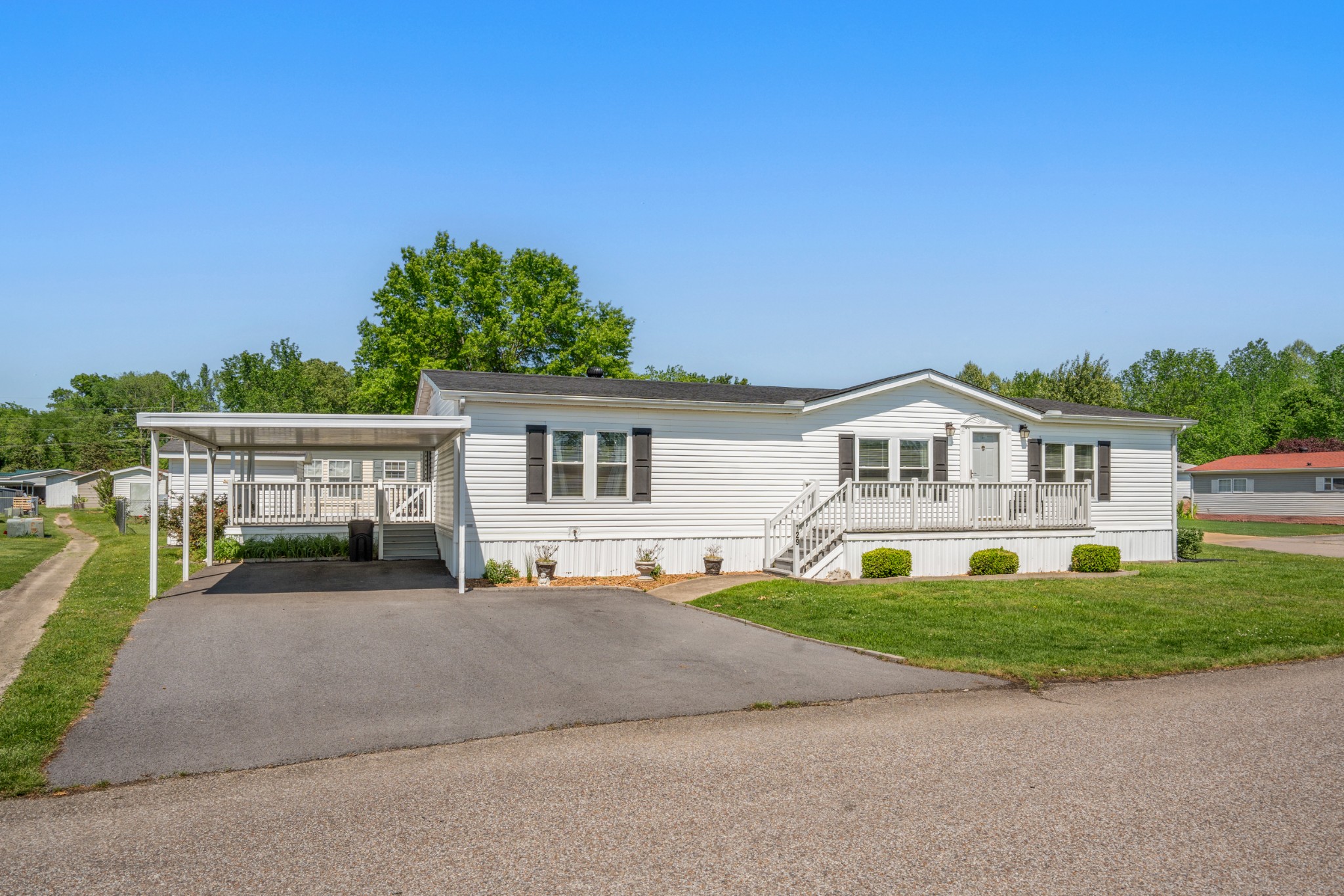 129 Broken Arrow Paris, TN 38242 - Photo 2 of 49 a front view of a house with a yard and garage