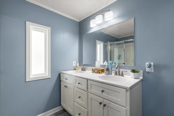 a bathroom with 2 sink tub and a mirror