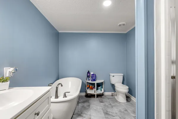 a white toilet sitting next to a bathroom sink