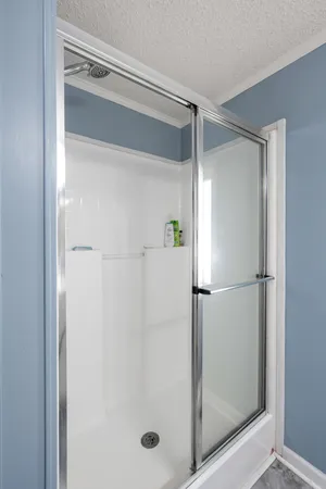 a bathroom with a glass shower door