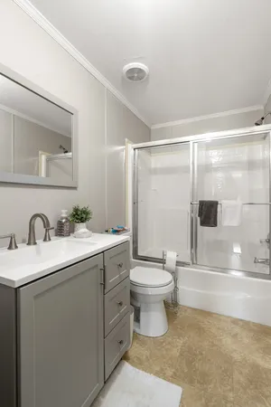 a bathroom with a sink toilet a mirror and shower