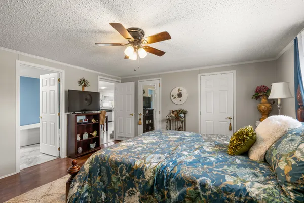 a bedroom with a bed and a flat screen tv