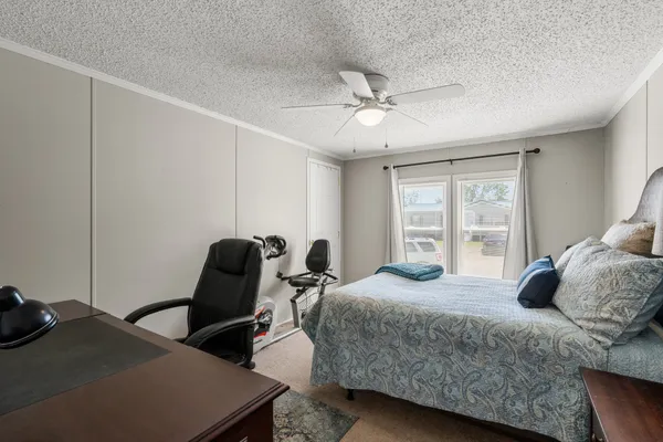 a bedroom with a bed a desk and chair