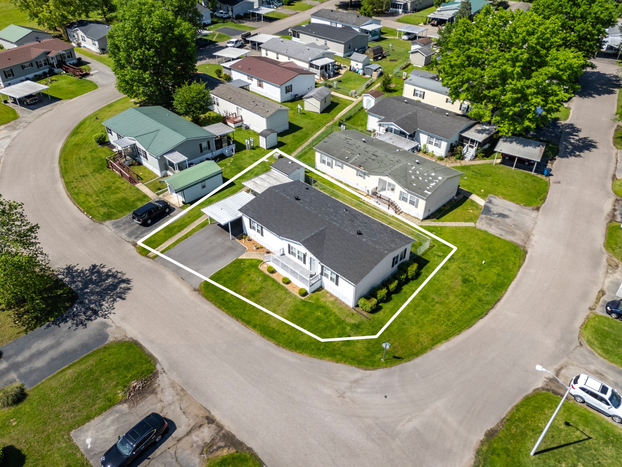 129 Broken Arrow Paris, TN 38242 - Photo 44 of 49 an aerial view of a tennis ground and a large pool