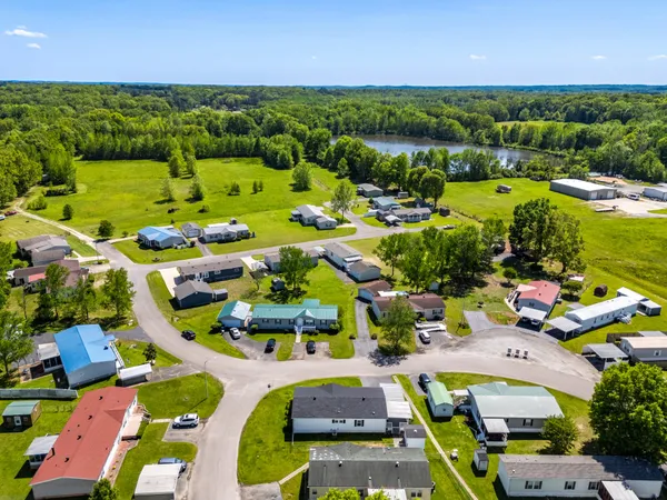 an aerial view of residential houses with outdoor space and river