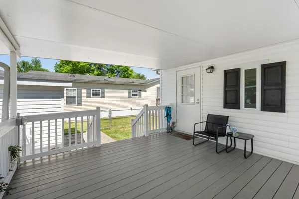 a porch with seating space and hardwood floor