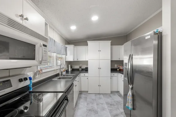 a kitchen with stainless steel appliances cabinets a sink and a counter top space
