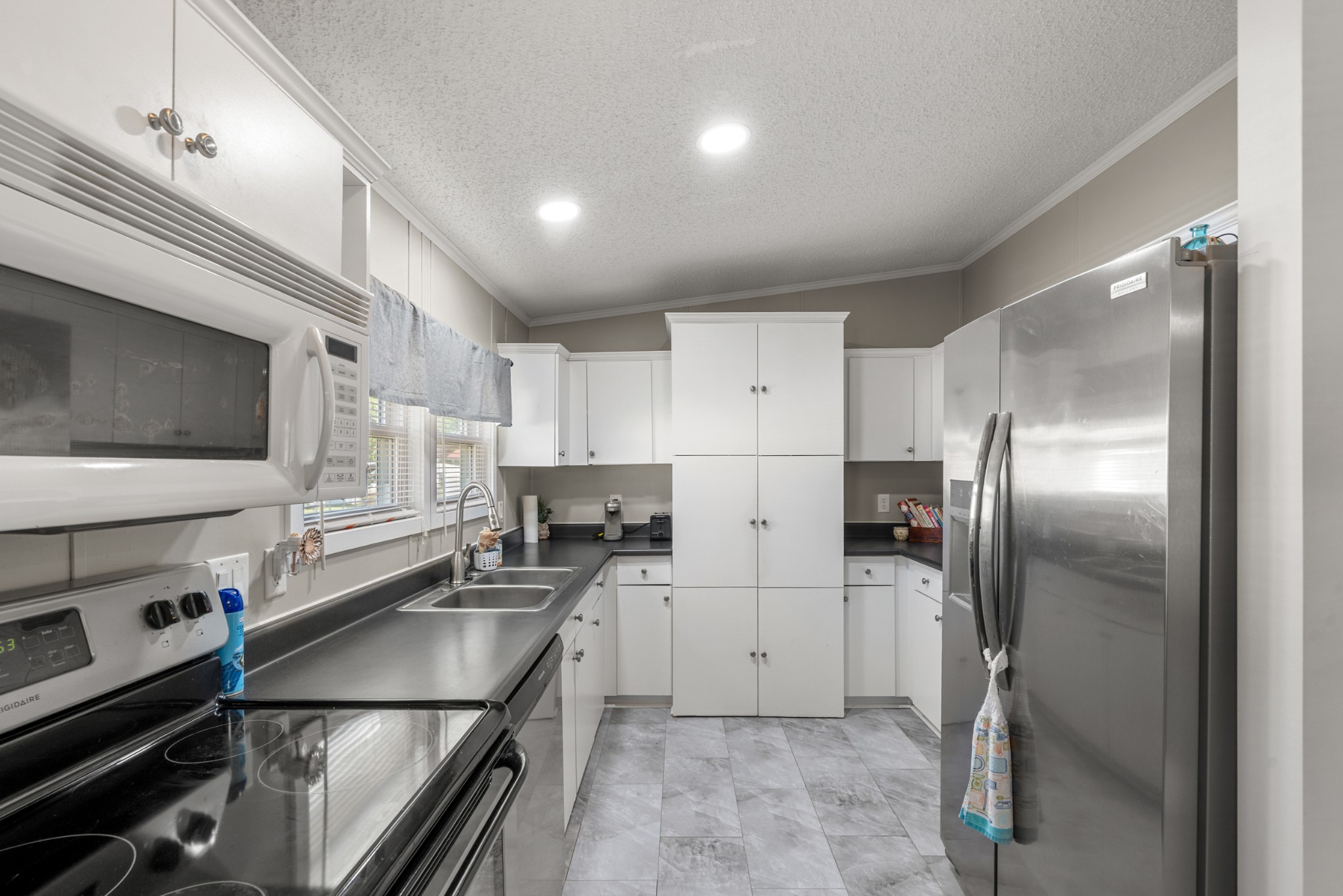 129 Broken Arrow Paris, TN 38242 - Photo 8 of 49 a kitchen with stainless steel appliances cabinets a sink and a counter top space