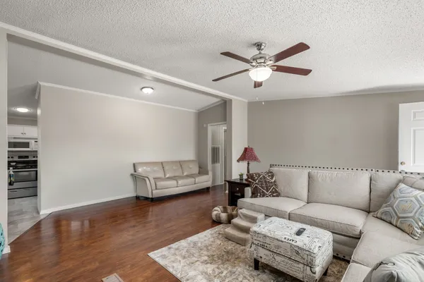 a living room with furniture and wooden floor