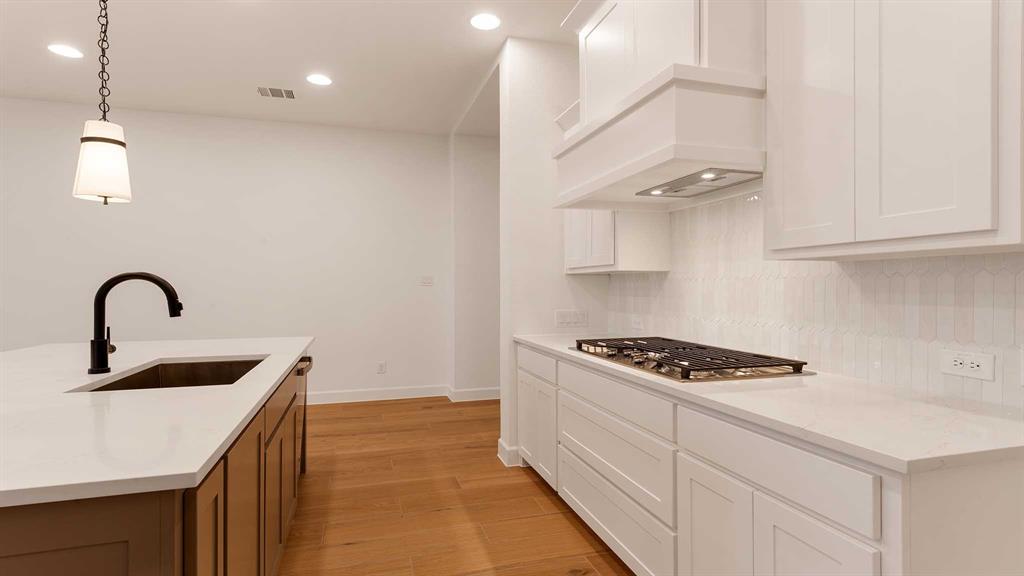 829 Stoney Bridge Way Lavon, TX 75166 - Photo 10 of 35 a kitchen with granite countertop a sink stove and cabinets