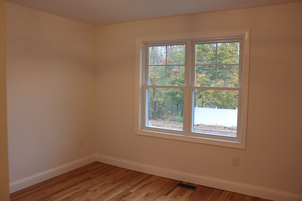 30 Maple Street Hudson, MA 01749 - Photo 20 of 36 a view of a room with wooden floor and windows