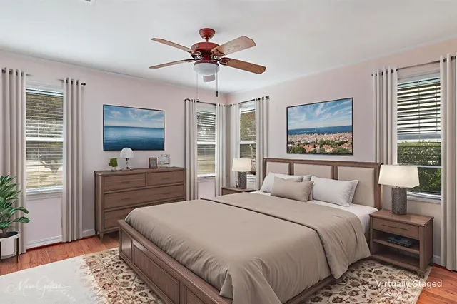 a bedroom with a large bed and a flat tv screen on dresser