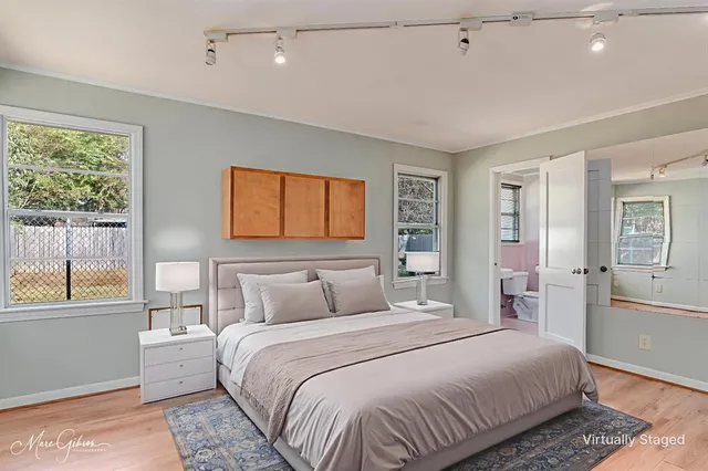 a bedroom with a large bed and a window