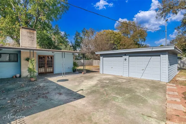 a swimming pool is in the backyard of house