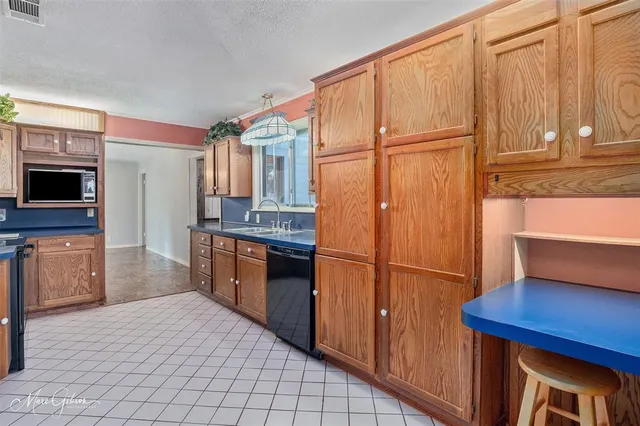 a kitchen with stainless steel appliances a refrigerator and a stove top oven