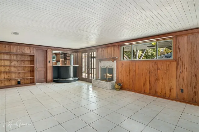 an empty room with furniture and window