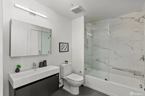 a view of a roof deck with couches and potted plants
