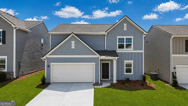 a front view of a house with a yard and garage