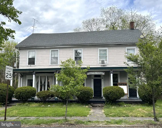 a front view of a house with a yard and potted plants