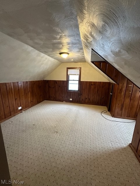 16104 Corkhill Road Maple Heights, OH 44137 - Photo 14 of 24 Bonus room with wood walls, lofted ceiling, and light colored carpet