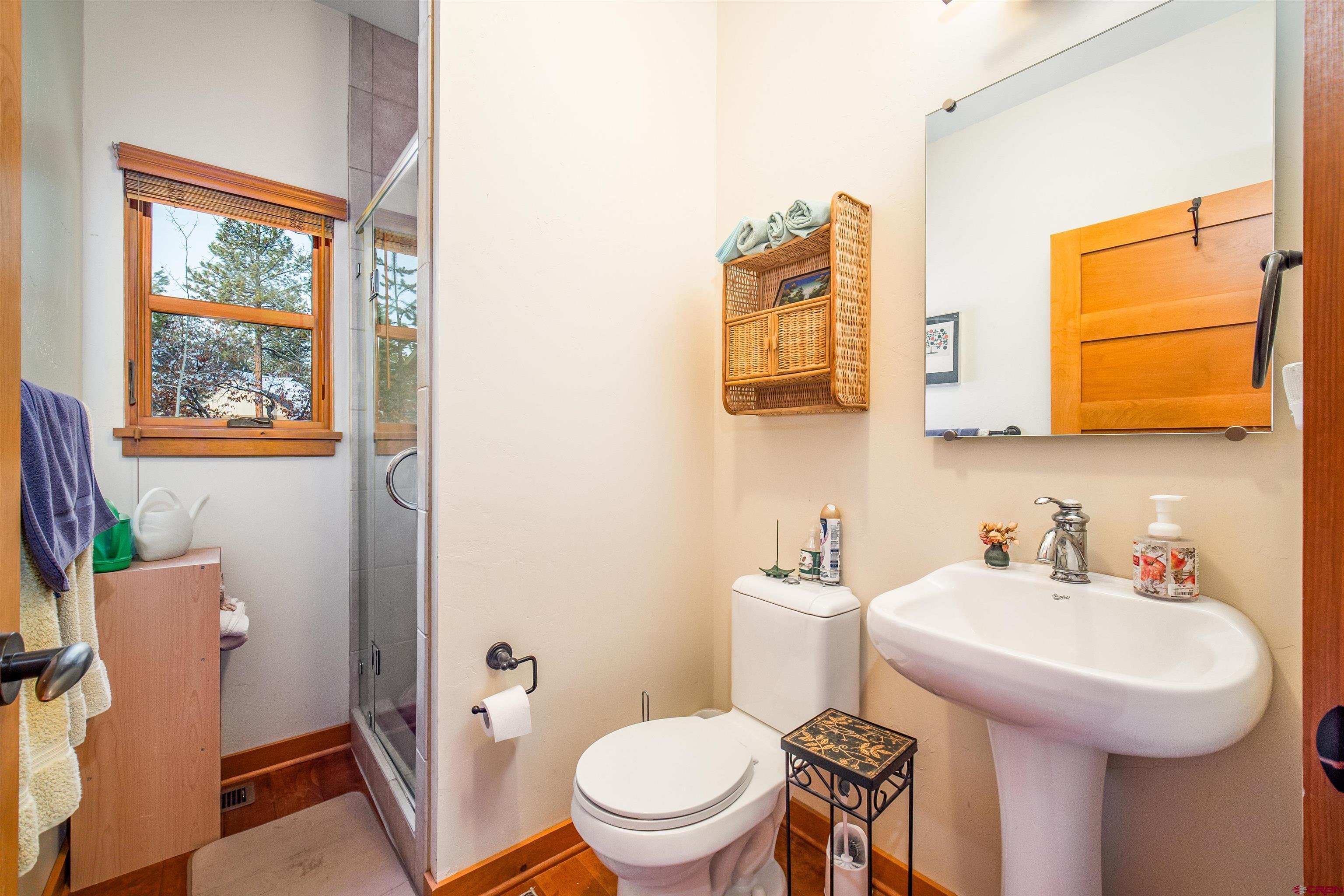 25 Red Table Court Durango, CO 81301 - Photo 15 of 34 a bathroom with a sink mirror and toilet