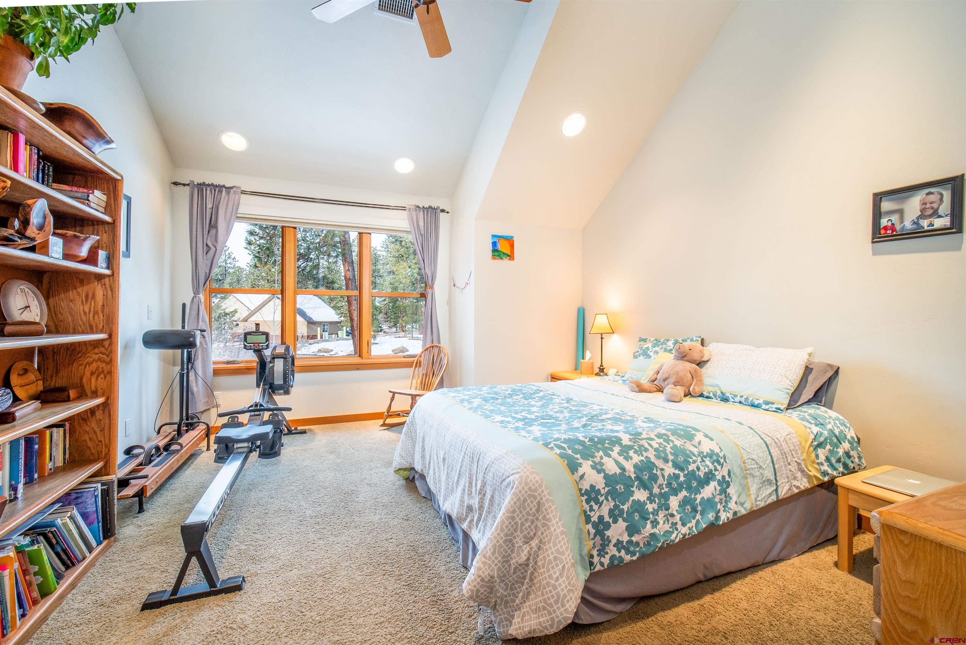 25 Red Table Court Durango, CO 81301 - Photo 20 of 34 a bedroom with a bed furniture and a book shelf