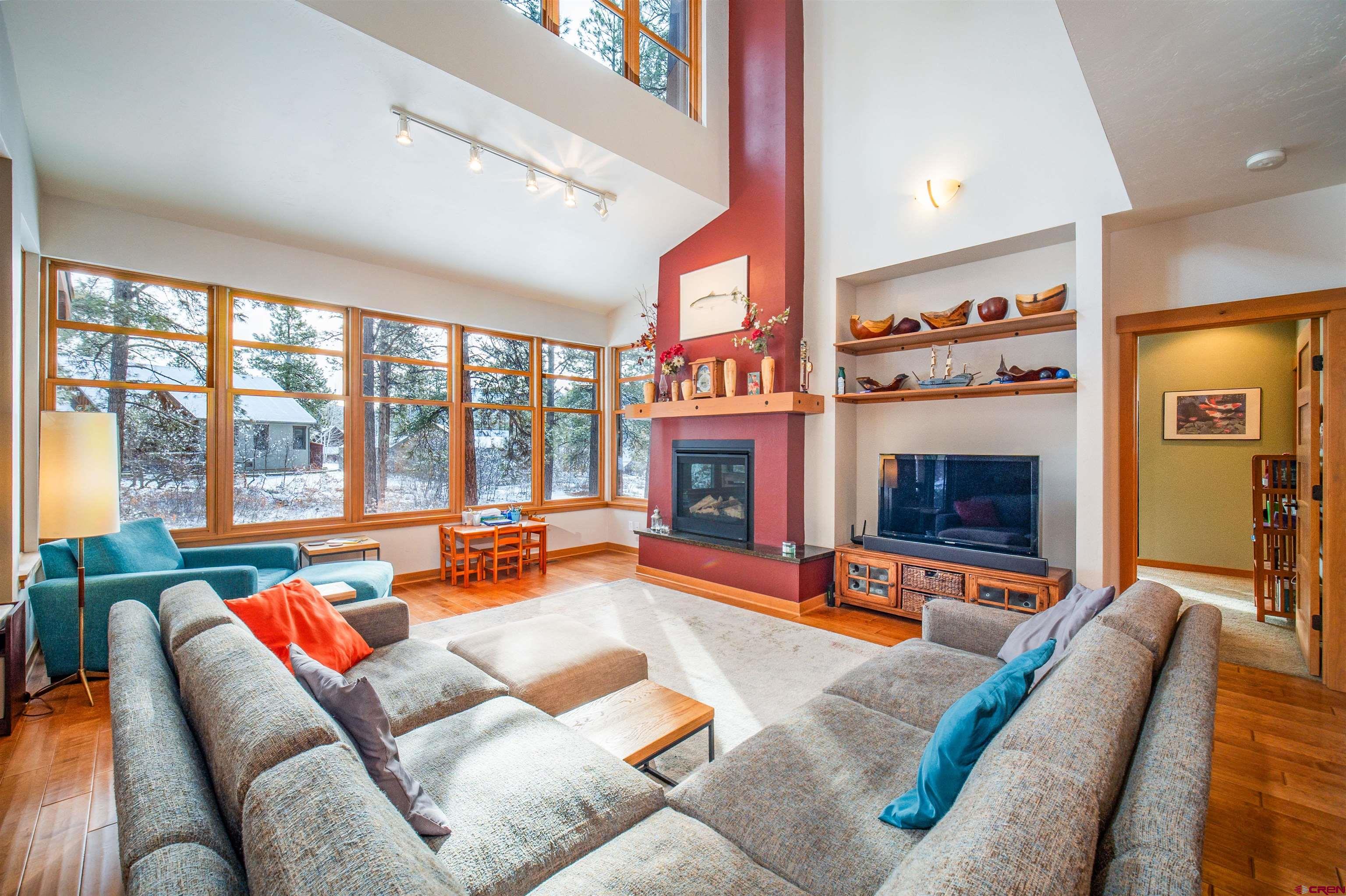 25 Red Table Court Durango, CO 81301 - Photo 2 of 34 a living room with furniture a fireplace and a large window