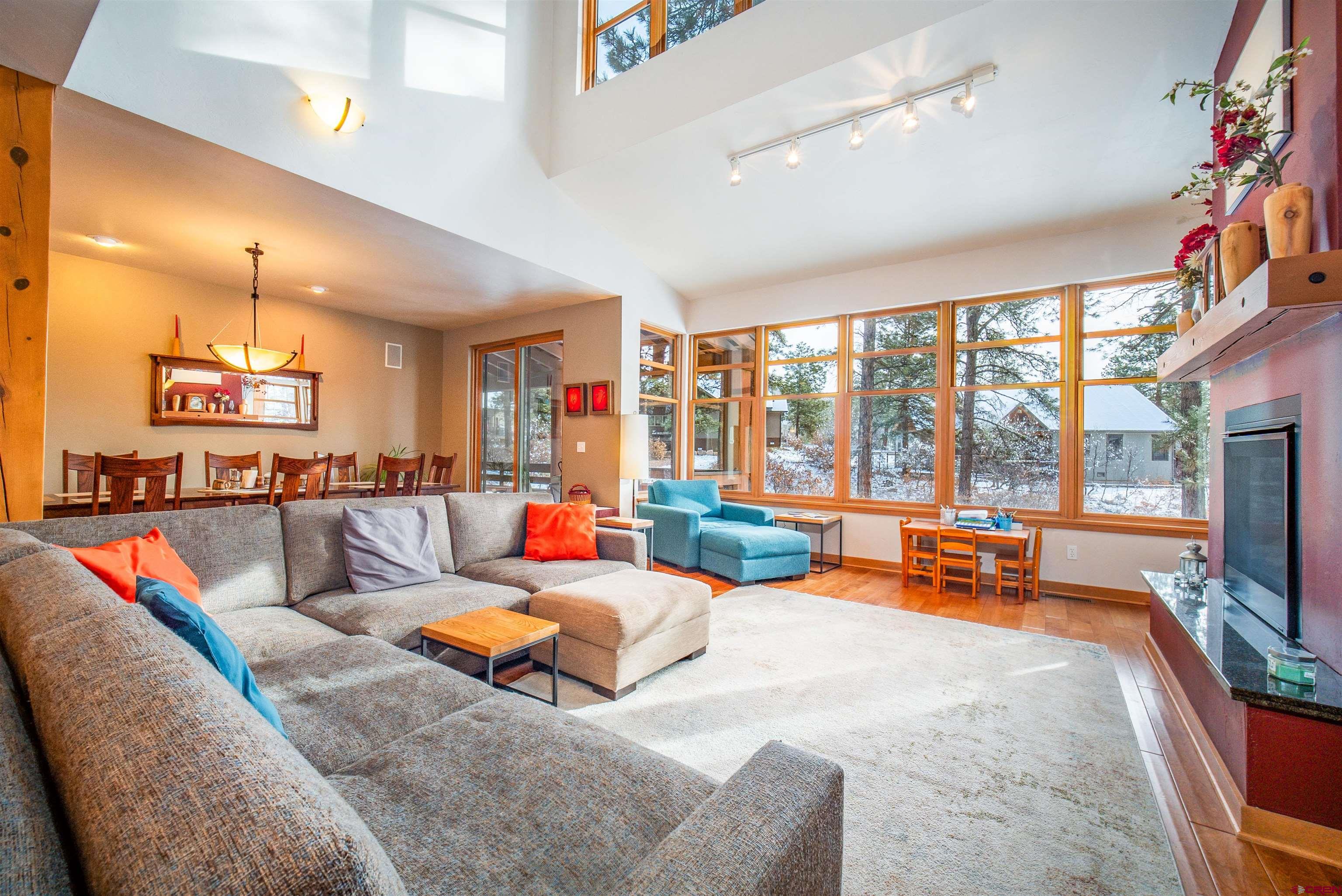 25 Red Table Court Durango, CO 81301 - Photo 3 of 34 a living room with furniture a flat screen tv and a large window