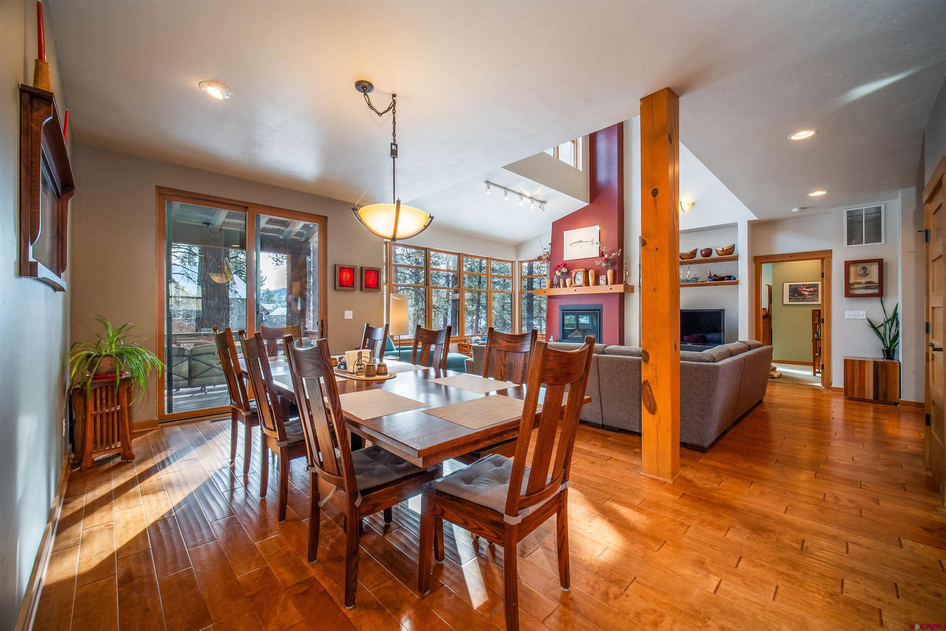 25 Red Table Court Durango, CO 81301 - Photo 5 of 34 a view of a dining room and livingroom with furniture wooden floor a rug a painting and a chandelier