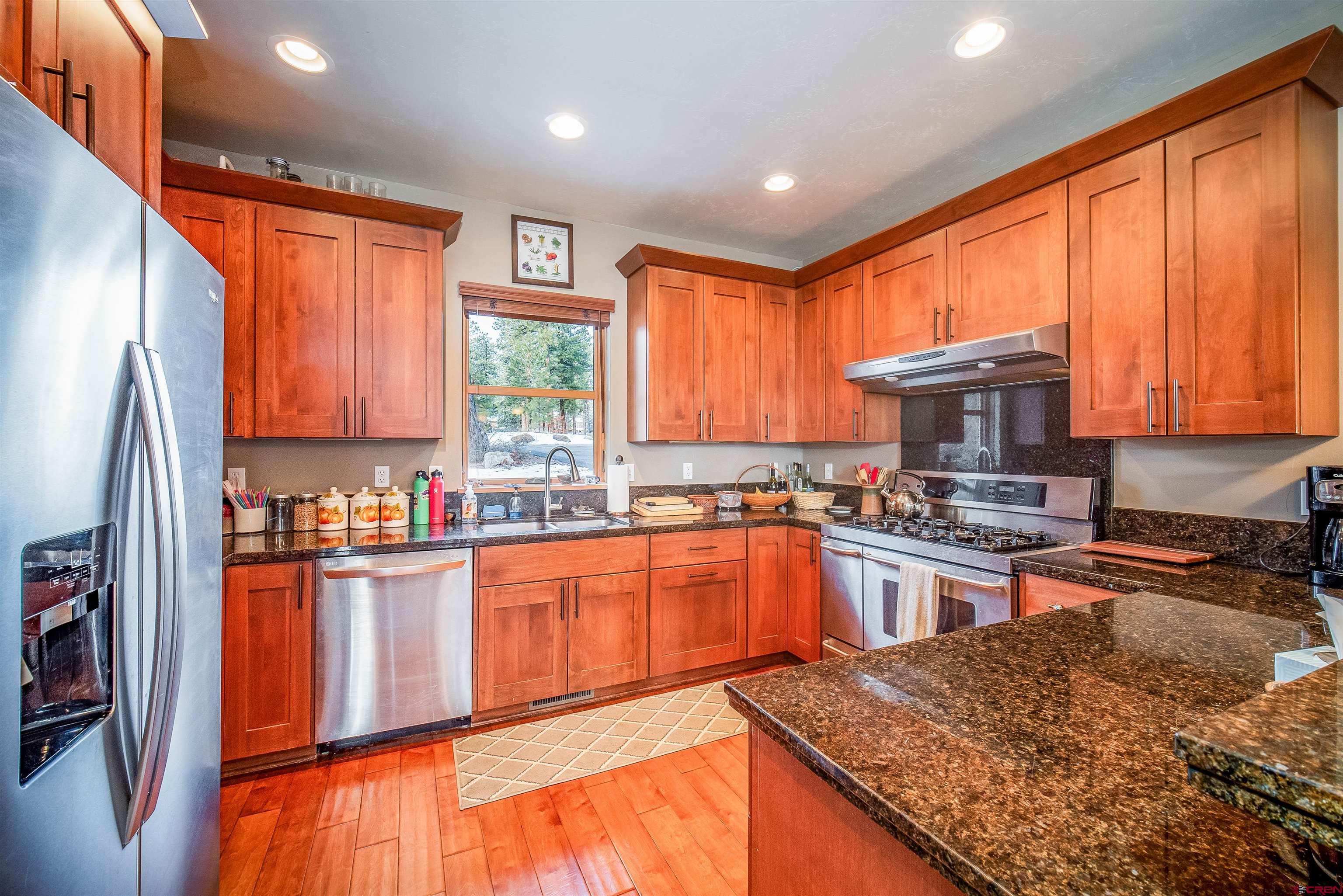 25 Red Table Court Durango, CO 81301 - Photo 7 of 34 a kitchen with stainless steel appliances granite countertop sink stove top oven and large window