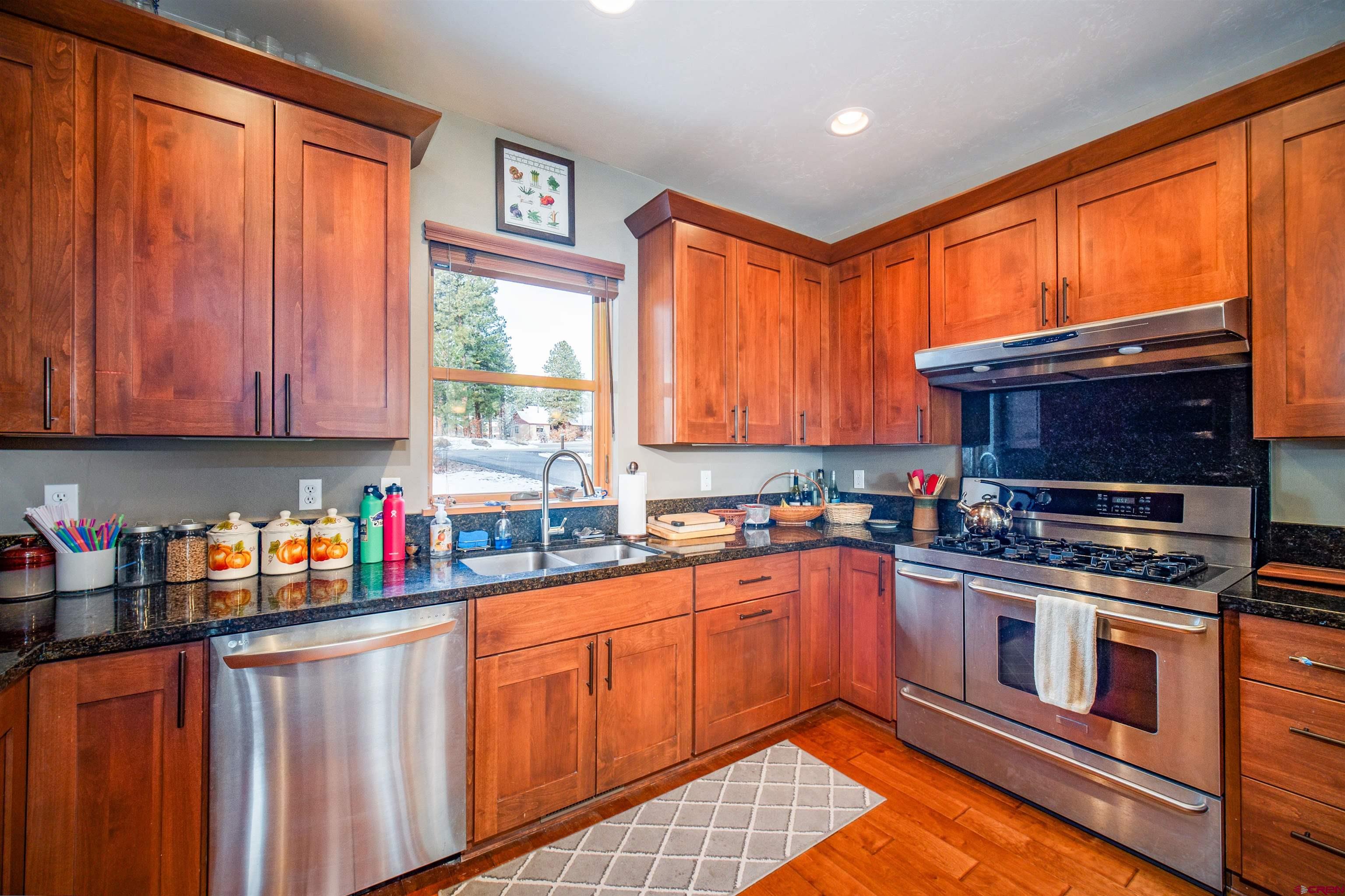 25 Red Table Court Durango, CO 81301 - Photo 8 of 34 a kitchen with stainless steel appliances a stove sink microwave and cabinets